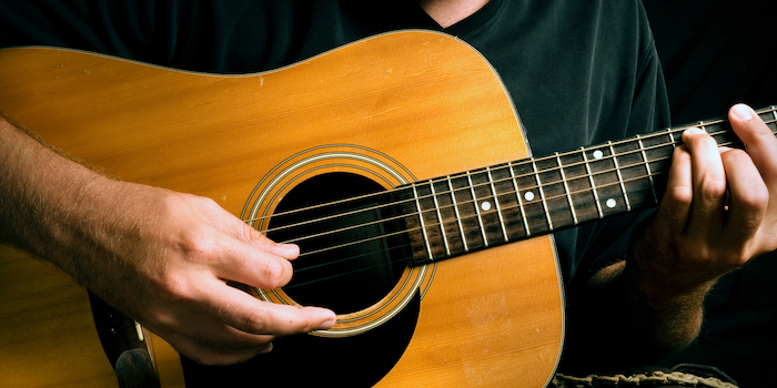 Man playing acoustic guitar.